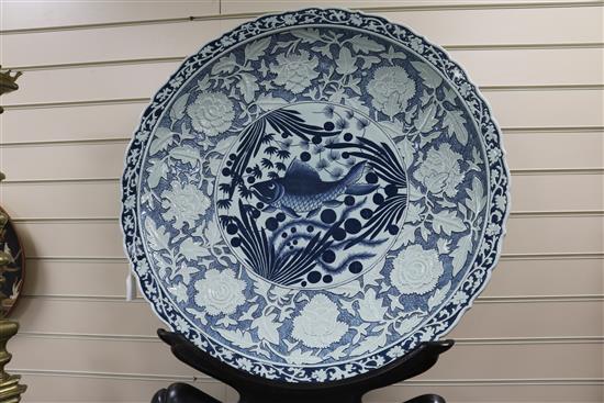 A large Chinese blue and white charger on stand